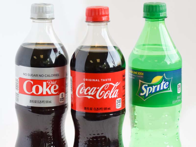 Three 20 ounce bottled beverages diet coke, coca-cola, and sprite