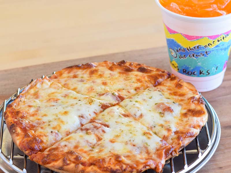 Solo sized kids cheese pizza on traditional crust and a kids sized orange pop