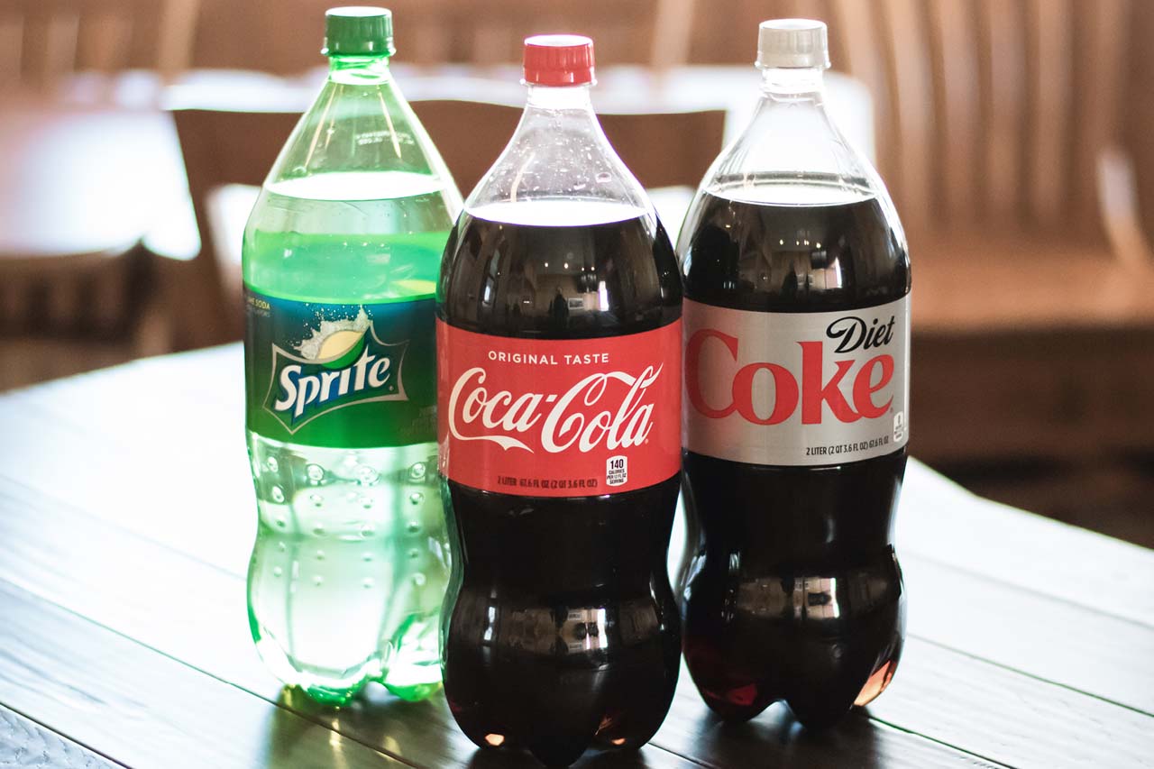 Three 2-Liter bottled beverages diet coke, coca-cola, and sprite