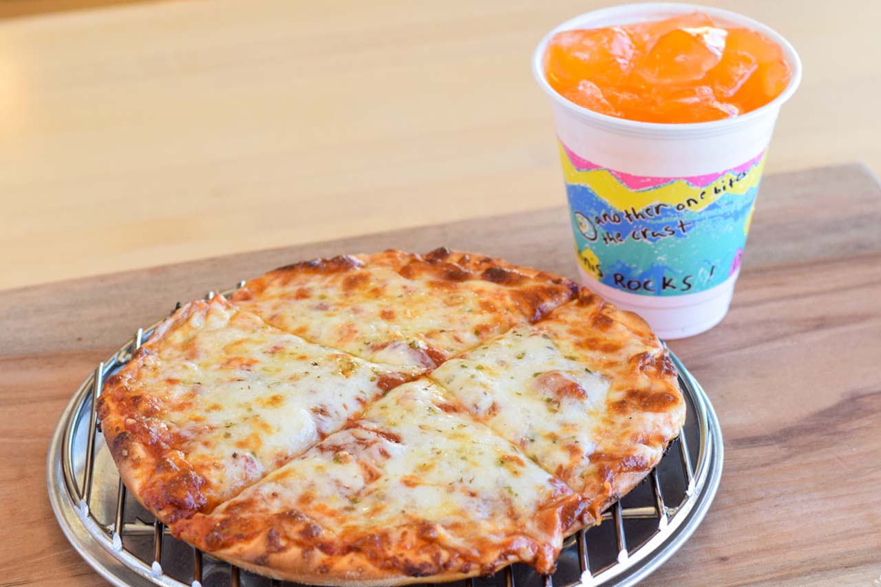 Solo sized kids cheese pizza on traditional crust and a kids sized orange pop