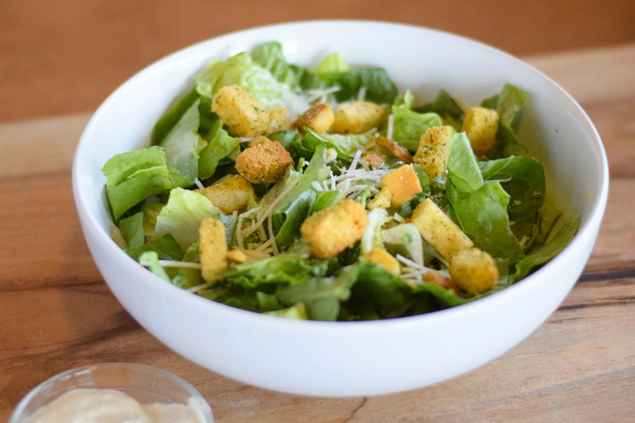 Entree sized caesar salad with croutons and sprinkled shredded romano cheese. Served with a side of caesar dressing.