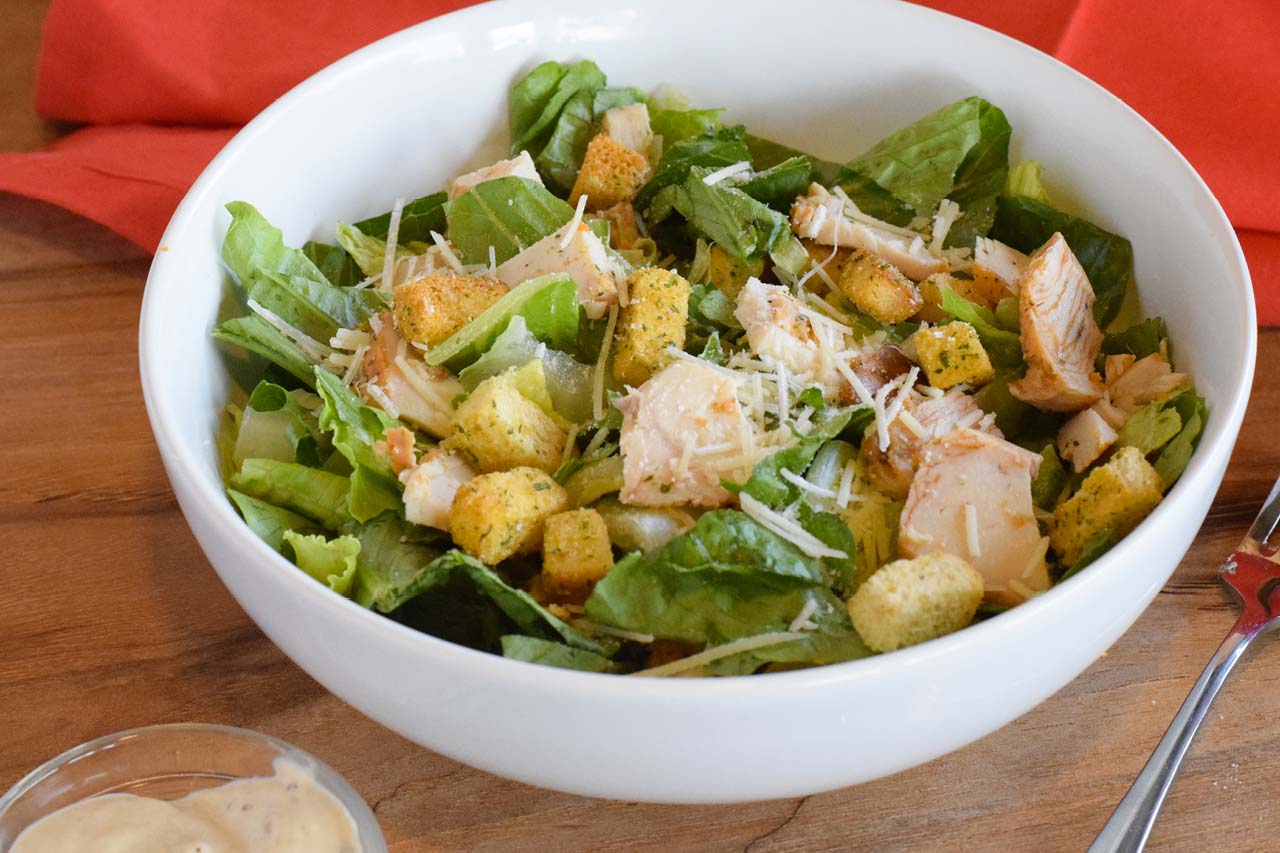 Entree sized caesar salad with croutons, chicken, and sprinkled shredded romano cheese. Served with a side of caesar dressing.