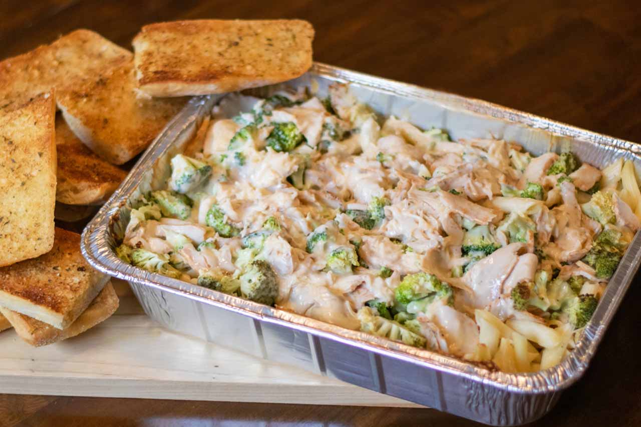 Pan size of Penne Pasta tossed with alfredo sauce, chicken and broccoli. Topped with shredded romano cheese and served with ciabatta garlic toast.