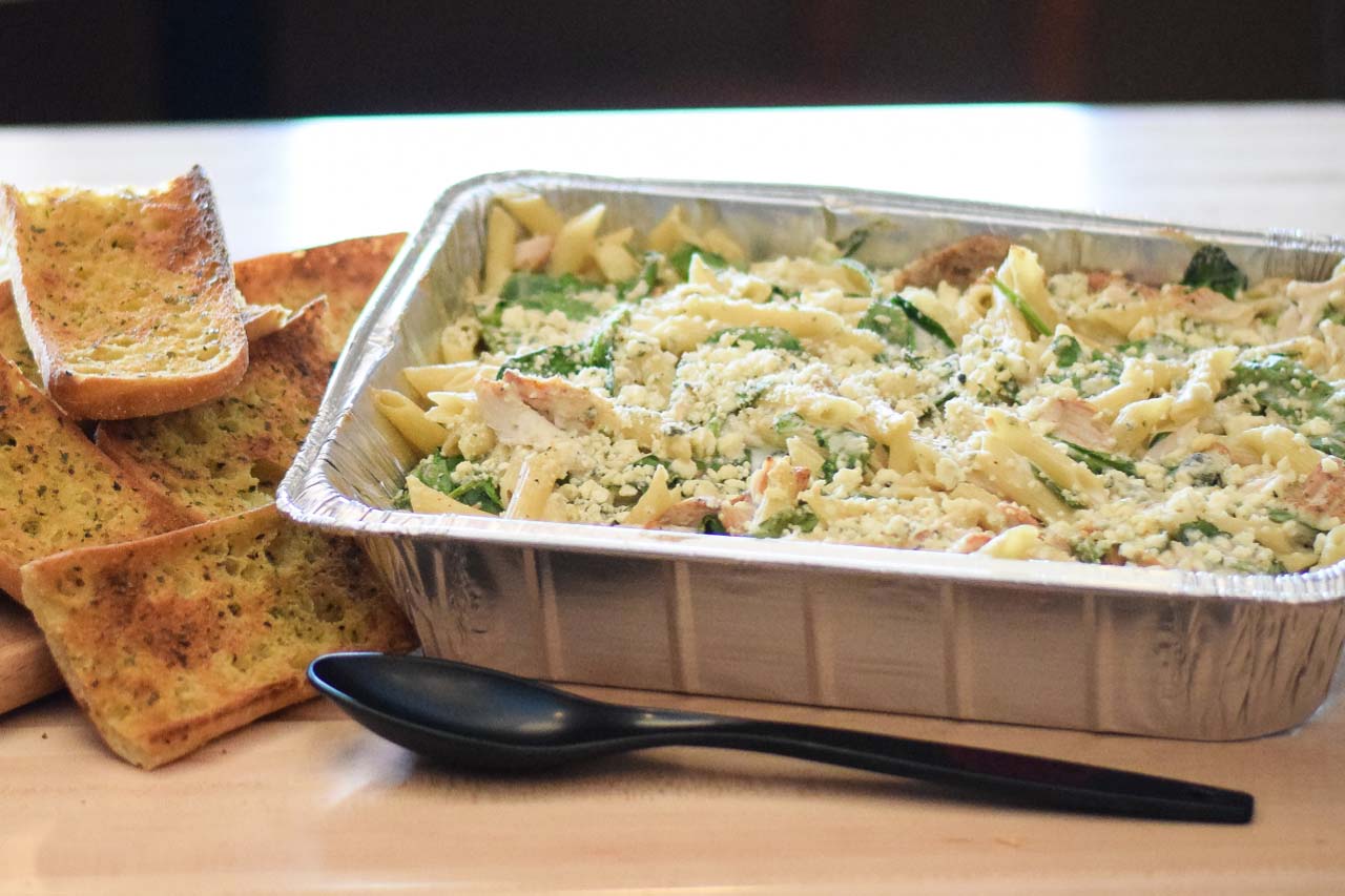 Pan of pasta with alfredo sauce, chicken, spinach, and topped with melted Gorgonzola cheese. Served with ciabatta garlic toast.